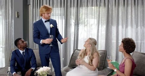 Multicultural wedding reception cheers with toasts and smiles