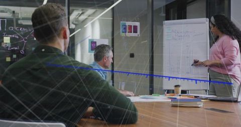 Team Collaborating on Presentation with Charts in Modern Office