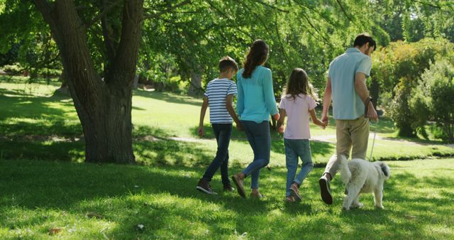 Happy Family Walks Dog in Sunny Park - Download Free Stock Images Pikwizard.com