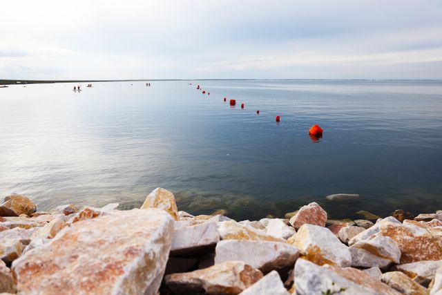 Serene Seaside with Calm Waters and Rock Shoreline - Download Free Stock Images Pikwizard.com