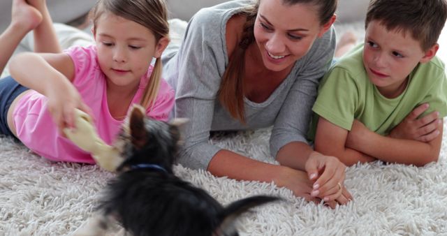 Mother and Children Playing with Pet Dog on Carpet at Home - Download Free Stock Images Pikwizard.com