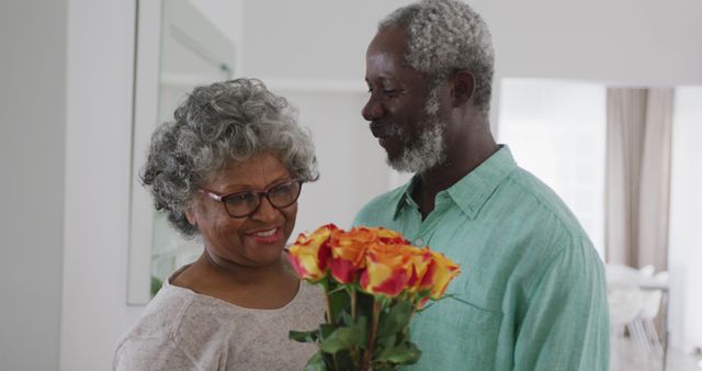 Happy Senior Couple Celebrating with Flower Bouquet at Home - Download Free Stock Photos Pikwizard.com