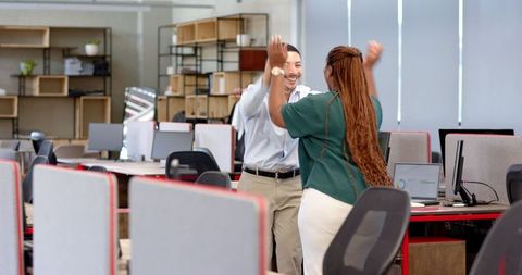 Excited Business Colleagues Celebrating Achievement in Modern Office