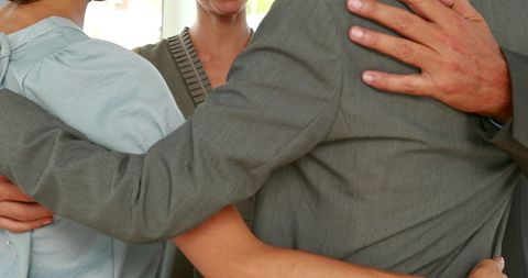 Supportive group hug displaying unity and comfort