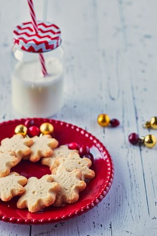 Festive Christmas Cookies with Milk Jar on White Table