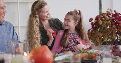 Happy Mother Cleaning Daughter’s Face During Family Dinner - Download Free Stock Images Pikwizard.com