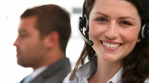 Smiling Customer Service Representative in Headset at Workplace