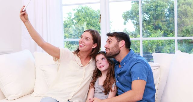 Happy Family Taking Selfie on Couch in Bright Living Room - Download Free Stock Images Pikwizard.com