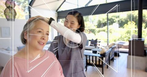 Caregiver Assisting Senior Woman at Home with HUD Tech Overlay for Wellness and Companionship