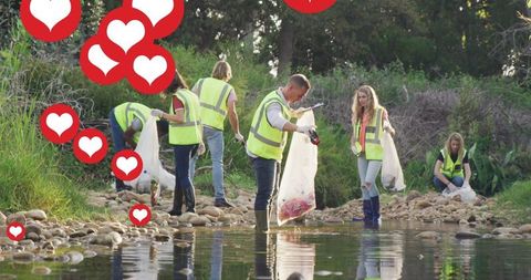 Volunteers Collecting Litter Near River Surrounded by Social Media Hearts