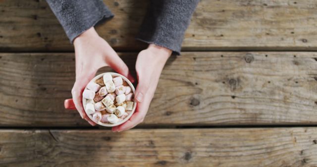 Hands Holding Hot Chocolate with Marshmallows on Rustic Wooden Table - Download Free Stock Images Pikwizard.com