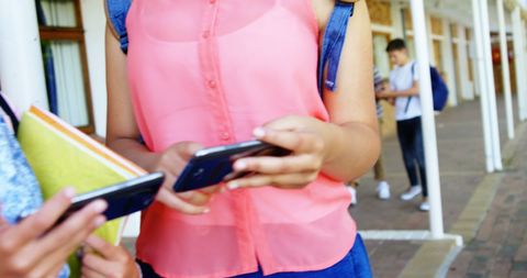 Schoolgirls Using Smartphones on School Campus for Social Interactions - Download Free Stock Images Pikwizard.com
