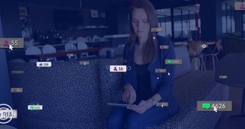 Woman tapping tablet in modern coworking lounge with social notifications and ui overlays