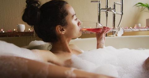 Relaxed Woman Enjoying Bath with Wine and Rose Petals - Download Free Stock Images Pikwizard.com