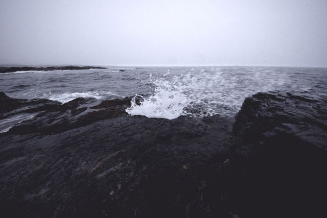 Waves Crashing on Rocky Shoreline in Overcast Weather - Download Free Stock Photos Pikwizard.com