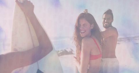 Friends Enjoying Beach Adventure Holding Surfboards at Shore