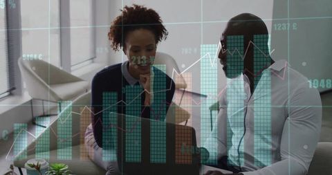 Colleagues Analyzing Data with Charts Overlays in Modern Office