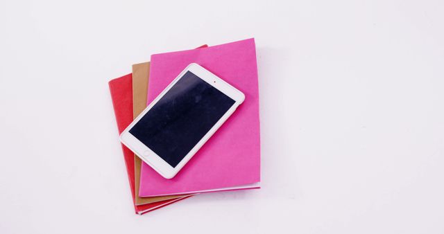 Smartphone on Colorful Notebooks with White Background - Download Free Stock Images Pikwizard.com