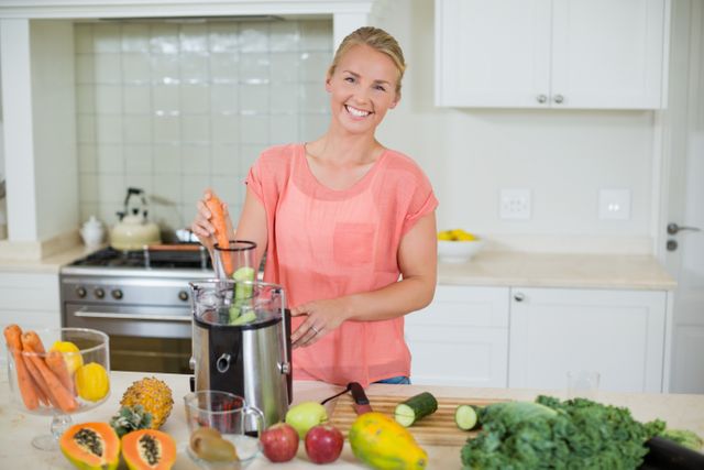 Woman is preparing fresh fruit juice in a modern kitchen, surrounded by various fruits and vegetables. Ideal for use in articles or advertisements related to healthy living, nutrition, home cooking, and wellness. Perfect for illustrating concepts of domestic life and happiness.