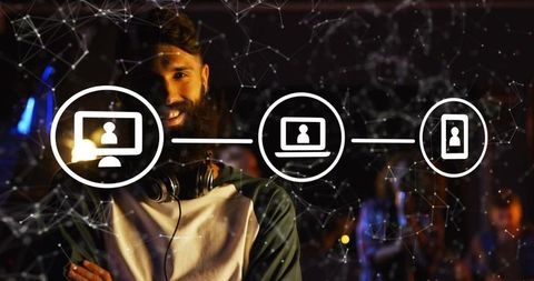 Smiling bearded man wearing headphones standing in moody event venue with network overlay