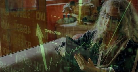 Businesswoman analyzing stock trends on tablet with overlay