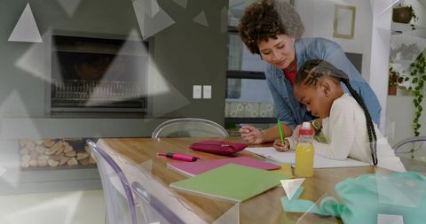 Woman tutoring child at dining table helping with homework nurturing family moment