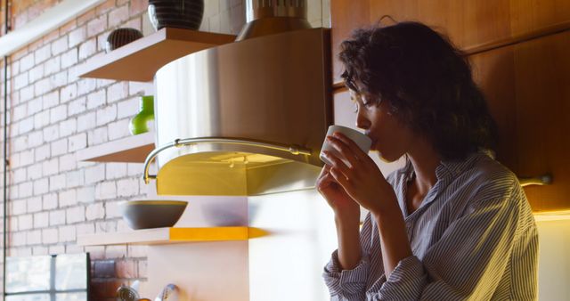 Woman Enjoying Morning Coffee in Cozy Kitchen with Modern Decor - Download Free Stock Images Pikwizard.com