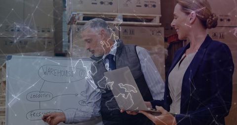 Team Strategizing Logistics with Whiteboard and Laptop in Modern Warehouse