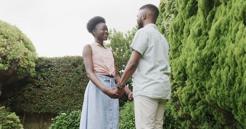 Romantic proposal in lush garden setting captures love and joy