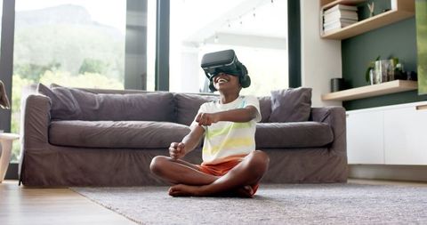 Joyful Boy Engaging with Virtual Reality Technology at Home