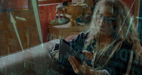 Investor Analyzing Financial Data on Tablet at Home