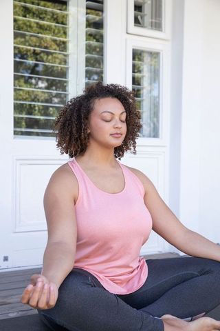 Peaceful Woman Practicing Meditation on Outdoor Porch