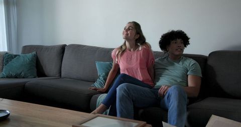 Young Couple Relaxing Together on Couch in Cozy Living Room