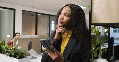Professional woman contemplating future in modern office environment