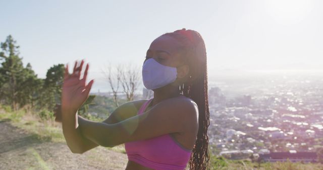 Woman Wearing Mask Enjoying Outdoor Exercise Above City Skyline - Download Free Stock Images Pikwizard.com