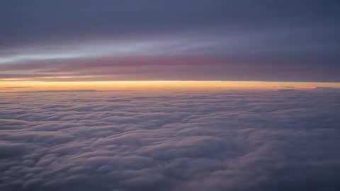 Sun Rising Casting Warm Glow Over Cloud Layer at Dawn