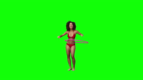 Woman in Bikini Using Hula Hoop on Green Background