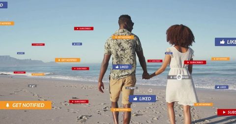 Couple holding hands walking on sunny beach with floating social media notifications