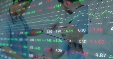 Medical team analyzing healthcare data dashboard with financial market overlay