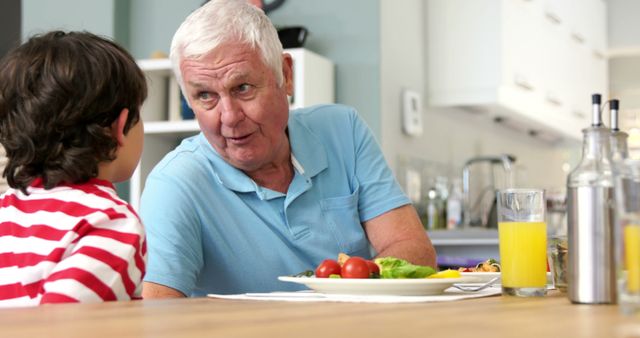 Grandfather Sharing Stories with Grandson Over Breakfast - Download Free Stock Images Pikwizard.com