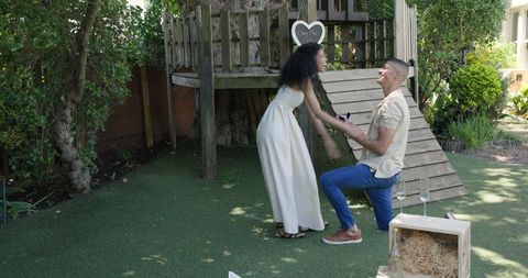 Romantic Proposal in Garden with Man on Knee