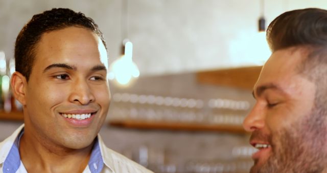 Two Men Enjoying Conversation in a Modern Cafe - Download Free Stock Images Pikwizard.com