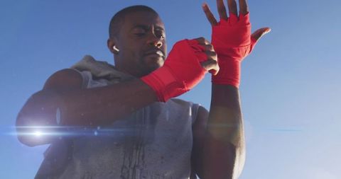 Athletic Man Wrapping Hands for Fitness Training