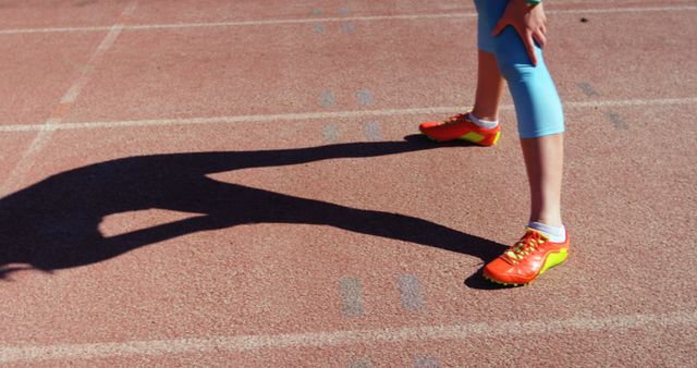 Athlete preparing for run on track wearing bright sneakers - Download Free Stock Images Pikwizard.com