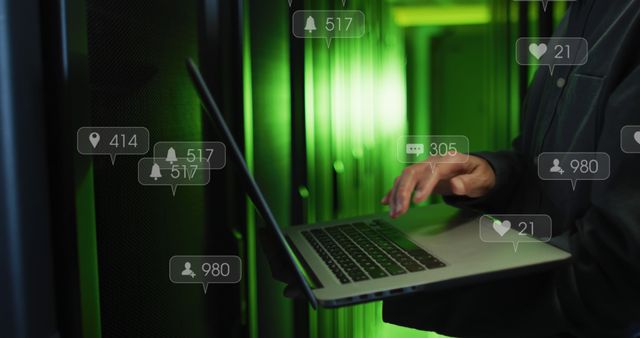 Person working on a laptop in a data center filled with glowing green lights, surrounded by floating social media notifications. Ideal for use in articles, presentations, and advertisements about technology, social media influence, data management, and cybersecurity.