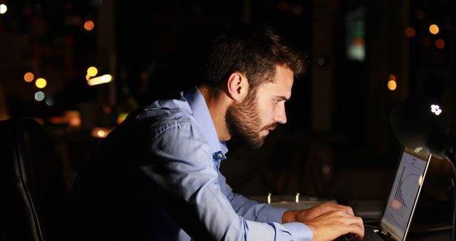 Focused Businessman Working Late on Laptop Analyzing Sales Data in Office at Night - Download Free Stock Images Pikwizard.com