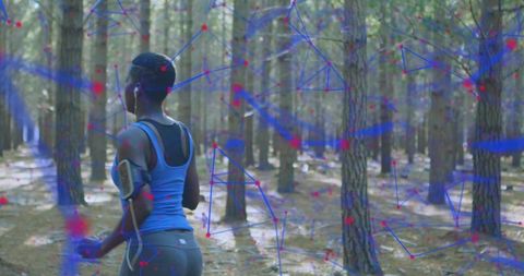 Running woman wearing earphones and armband in pine forest with futuristic data overlay