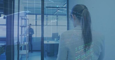 Business analyst examining financial data hologram at modern office