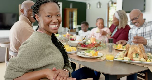 Smiling woman enjoying family gathering during holiday meal - Download Free Stock Images Pikwizard.com