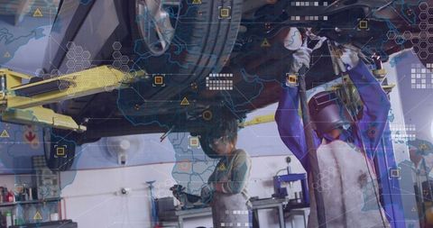 Automotive technicians welding under lifted car with digital hud overlay